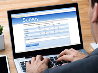 Cropped,Image,Of,Businessman,Giving,Online,Survey,On,Laptop,At